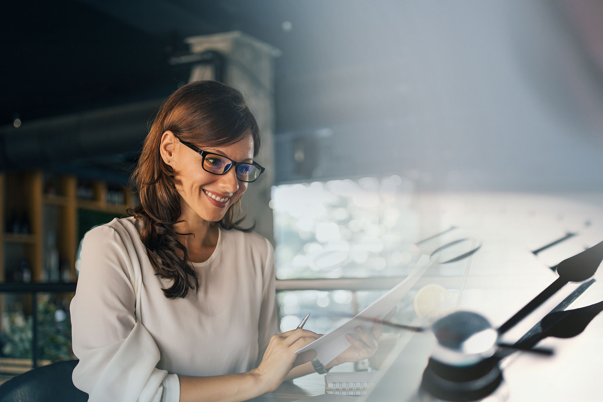 business woman looking happy at computer with a clock overlay